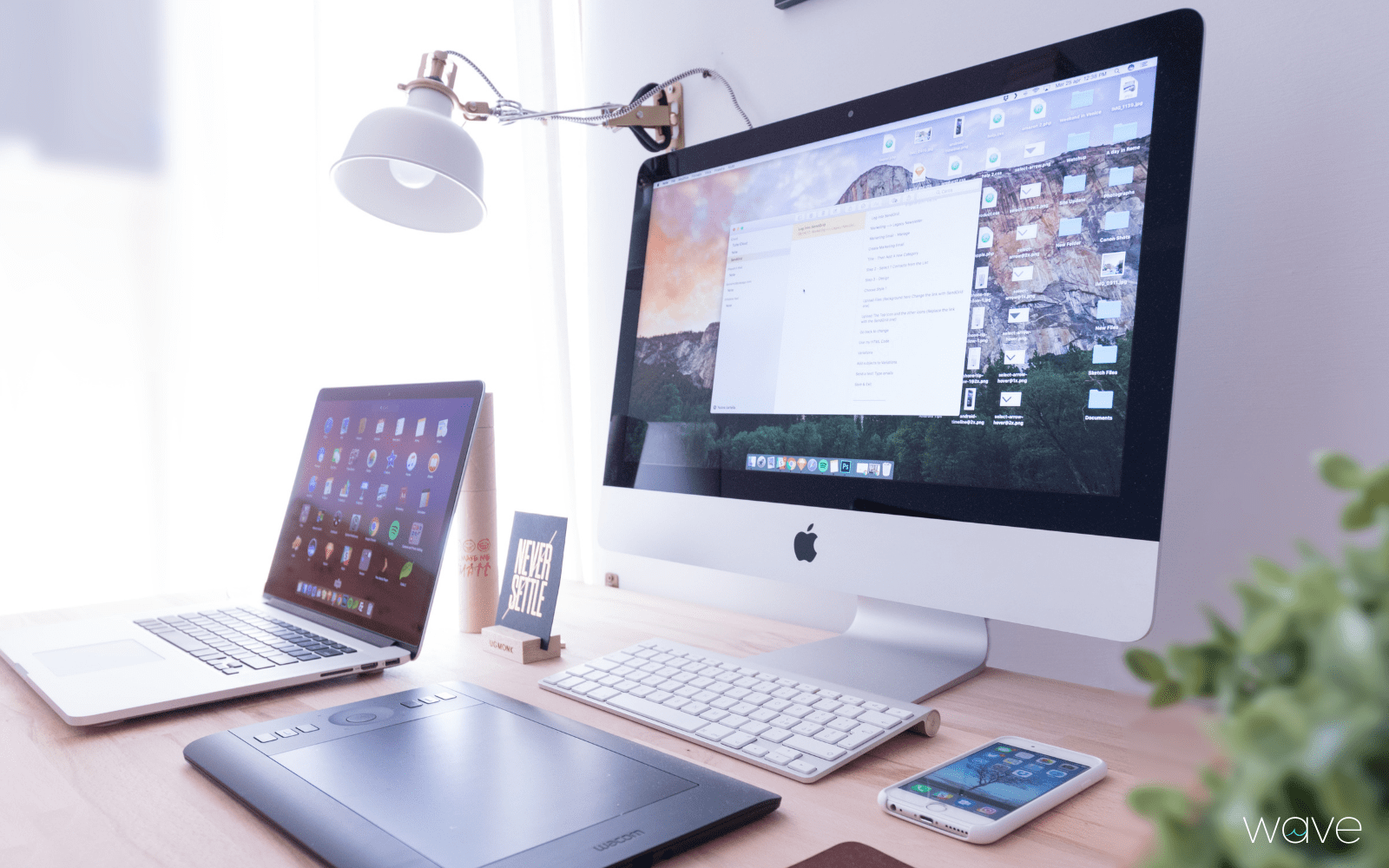 computer, phone, laptop, on desk for a social media manager's office