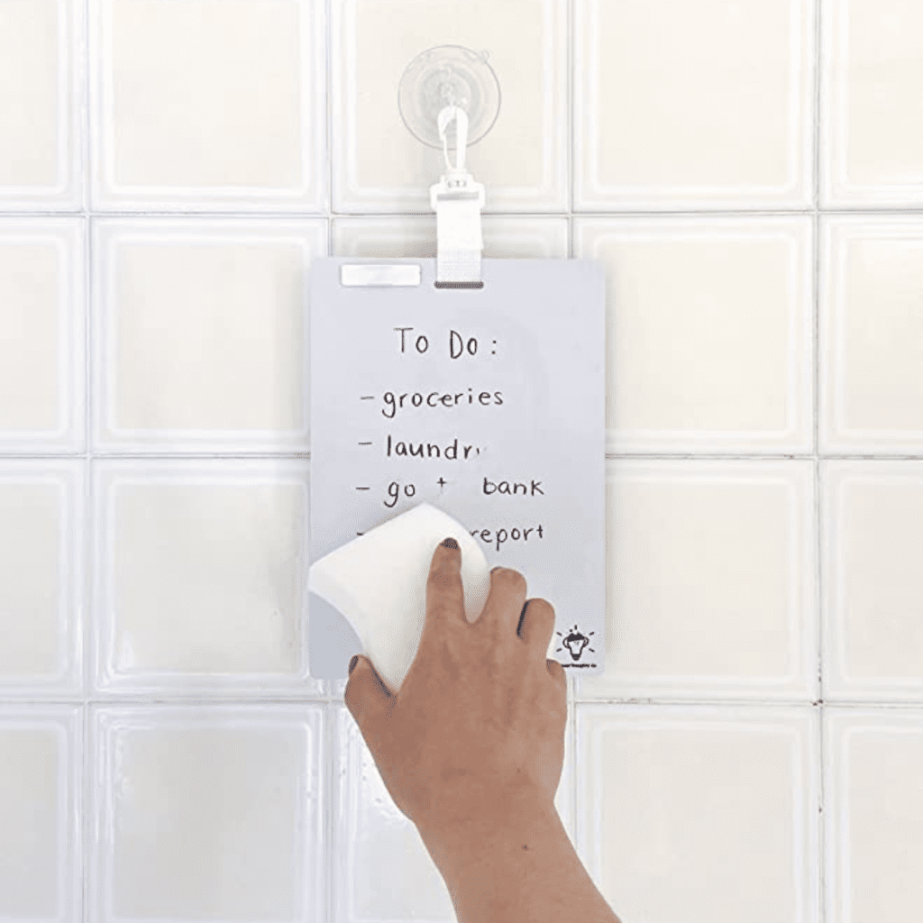 small waterproof white board hanging in the shower